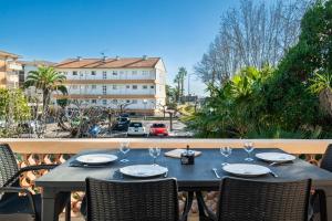 a table with wine glasses on a balcony at Courtille sur Mer - port de Frejus in Fréjus