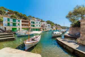 a group of boats docked in a canal with buildings at Villa Ca Sa Padrina in Santanyi