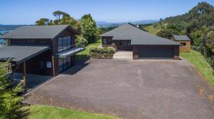 an aerial view of a house with a garage at Treetops Cottage at the Castle in Whitianga