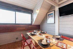 a dining room with a wooden table and chairs at Le Domaine du Lary in Saint-Lary-Soulan