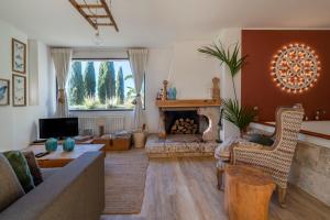 a living room with a couch and a fireplace at Villa Torto with private pool in Monopoli