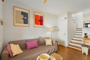 a living room with a couch and a staircase at Maspalomas Green Oasis in San Bartolomé