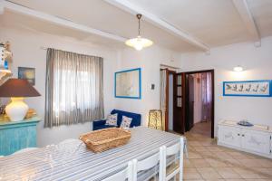 a room with a bed and a table and chairs at mirtagru casa dell'olivastro in Agrustos +17 photos