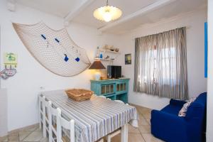 a living room with a table and a hammock at mirtagru casa dell'olivastro in Agrustos