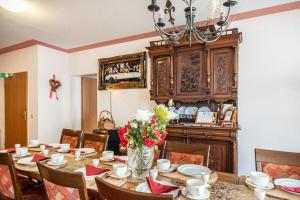 a dining room with a table and a chandelier at Ferienwohnung 1 in Bernkastel-Kues +15 photos