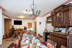 a dining room with a table and chairs and a chandelier at Ferienwohnung 1 in Bernkastel-Kues
