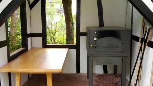 a stove and a bench in a room with a window at Hohle Kirche in Hiltpoltstein