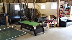 a room with a pool table and ping pong tables at Hohle Kirche in Hiltpoltstein +12 photos