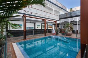 a swimming pool in front of a building at Casa Paula - 22 in Arinaga