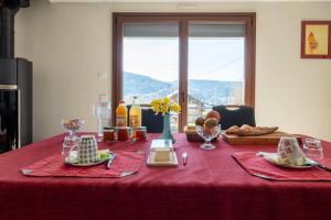 a table with a red table cloth with food on it at Le Chalet des Beuquillons in Gérardmer +14 photos