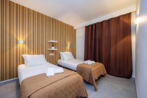 a hotel room with two beds and a window at First Line Cosy Apartment in Calvià +29 photos