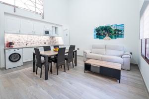 a kitchen and living room with a table and chairs at Ocean Suites A3 in Isla Cristina