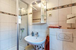 a bathroom with a sink and a shower at Brujosenhof in Oppenau +23 photos