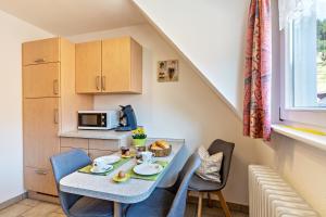 a small kitchen with a table and chairs in a room at Brujosenhof in Oppenau