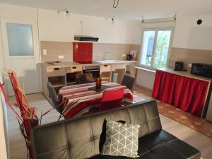 a living room with a couch and a table at Chambre Écureuil in L'Ile-Bouchard
