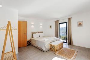 a bedroom with a bed and a ladder and a window at Casa Do Alago in Gove +21 photos