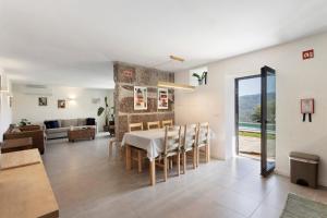 a dining room and living room with a table and chairs at Casa Do Alago in Gove