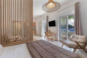 a bedroom with a bed and a living room at Luxsuites in Chania