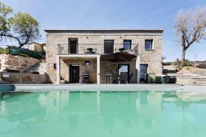 a villa with a swimming pool in front of a house at Casa Do Alago in Gove