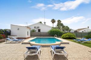 a swimming pool with lounge chairs and a house at Villa Perez Zara Carmelo in Campano