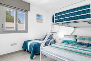 a bedroom with a bunk bed and a window at Villa Adán con Piscina Majestuosa in Cádiz +23 photos
