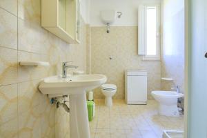 a bathroom with a sink and a toilet at Mare Etrusco 5 in Populonia +16 photos
