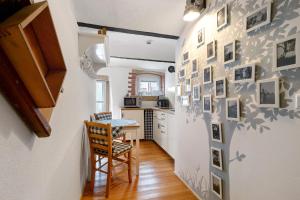 a kitchen with a hallway with a table and chairs at Stub'n Herbert in Waischenfeld