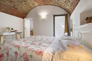 a bedroom with a large bed and a window at Ciliegio Agriturismo La Ferla in Toirano