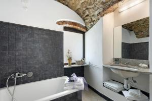 a bathroom with a bath tub and a sink at Ciliegio Agriturismo La Ferla in Toirano +20 photos