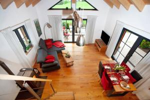 a living room with a table and some chairs at Schorenmoos Lodge in Dietmannsried +14 photos