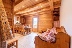 a living room with a couch and a table at Gite Les Clapières in La Giettaz