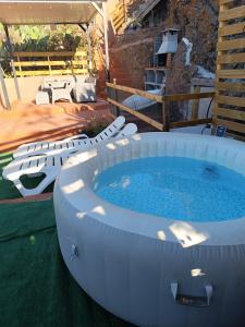 a large hot tub with chairs and a table at Ca' Navarro in Vega de San Mateo