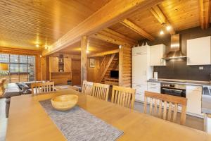 a kitchen and dining room with a table and chairs at Blockhaus Marie in Frielendorf
