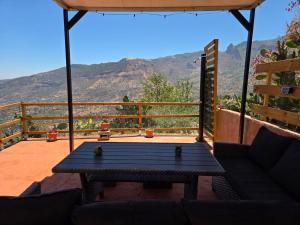 a patio with a table and a view of the mountains at Ca' Navarro in Vega de San Mateo
