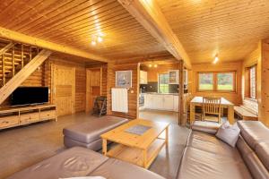 a living room with a couch and a table at Blockhaus Marie in Frielendorf