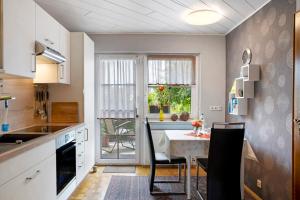 a kitchen with a table and a dining room at Ferienappartment Becker Zentrum in Lauterbach