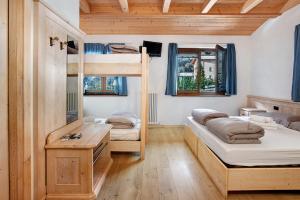 a room with two bunk beds and a desk at Agriturismo Quinto Quarto in Grosio +22 photos