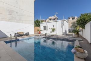 a swimming pool in the backyard of a house at Luxsuites in Chania