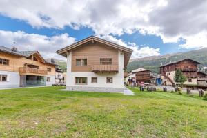 a house with a large yard in a village at Chalet Ale Livigno in Livigno