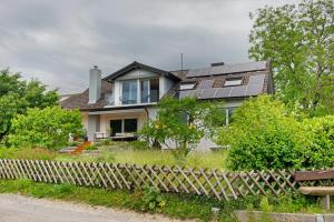 a house with solar panels on top of it at Aussichtsreich Am See in Uhldingen-Mühlhofen