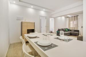 a kitchen and living room with a table and chairs at Las Américas Seafront - Free Wi-fi in Playa de las Americas