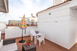 a room with a table and an umbrella on a balcony at Apartment Nieves 2 in Nerja +13 photos