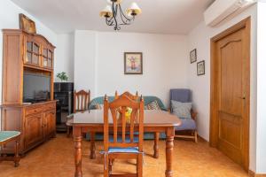 a dining room with a table and a tv at Apartment Nieves 2 in Nerja