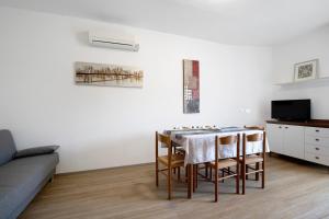 a living room with a table and a couch at Villa Trentina in Lido di Jesolo