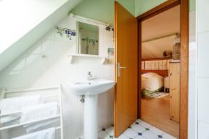 a bathroom with a sink and a door leading to a bedroom at Bienvenue-Willkommen in Boersch +43 photos