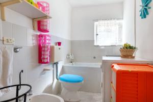a bathroom with a toilet and a bath tub at Trullo Nunuccio in Ceglie Messapica +28 photos