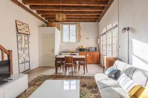 a living room with a couch and a table at La maison blanche in Nazelles