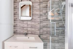 a bathroom with a sink and a mirror at La maison blanche in Nazelles