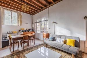 a living room with a couch and a table at La maison blanche in Nazelles +14 photos