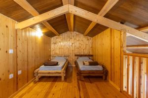 a room with two beds in a wooden cabin at Bungalow Alós in Alós de Balaguer +32 photos